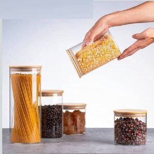بانکه درب چوبی پیرکس 5 سایز،این ظروف کارآمد برای خوراکی ها یا مواد پخت شکل و  عرضه می شوند. بانکه پیرکس  با درب های چوب بامبو، به راحتی میز و کابینت آشپزخانه خود را مرتب کنید. درب ها طراوت را برای نگهداری طولانی مدت مهروموم می کنند! غذاهای خشک مورد علاقه شما، میان وعده ها، پاستا، دانه های قهوه و کلوچه ها برای مدت طولانی تری تازه تر باقی می مانند.  بانکه پیرکس درب چوبی 5سایز ساخته شده از شیشه بروسیلیکات غیر سمی و بدون سرب. قابل شستشو در ماشین ظرفشویی هستند و با دستمال نرم پاک می شوند. بانکه پیرکس درب چوبی به راحتی به غذای خشک فله، شکر، غلات، برنج و چای خود دسترسی داشته باشید. از نظر زیبایی شناسی، شیشه های ما نیز یک نمایشگر عالی برای هر خانه ای هستند. ساخته شده با استفاده از مواد با کیفیت بالا، از شیشه بوروسیلیکات شفاف بادوام، واشر سیلیکونی قوی، و درب هایچوبی بامبو. یونیک محصولی را ایجاد کرده است که قابلیت اطمینان یک خانواده پرمشغله را دارد. ما می دانیم که خرید آنلاین شیشه گاهی اوقات می تواند نگران کننده باشد. ما در آرچه کالا هنگام حمل و نقل اقلام شیشه ای مراقبت بیشتر و بسته بندی مناسب می کنیم تا با خیال راحت به دست شما برسند. لوازم خانگی آرچه کالا arche kala  برای تمام نیازهای لوازم منزل شما، از لوازم آشپزخانه و دکوری  گرفته تا دکوراسیون منزل و منسوجات، اینجاست. چه برای خانه یا تجارت خود خرید می کنید.